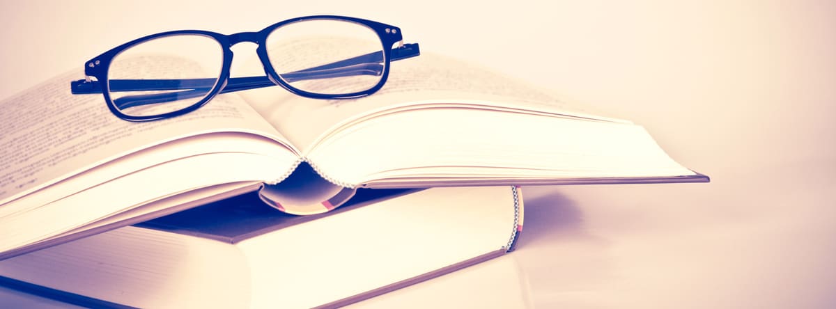 image of pair of glasses and book